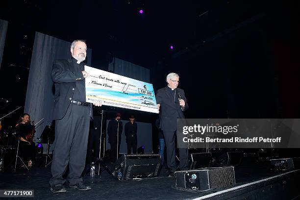 Monseigneur Pascal Gollnish Directeur des Oeuvres d orient receives a Check for 'les Chretiens d'Orient' by Monseigneur Jean-Michel di Falco Leandri...