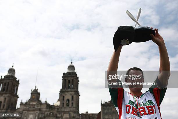 Jorge Cantu raises the trophy during the Home Run Derby as part of Mexican Baseball League 90th anniversary celebration at Main Square on June 14,...