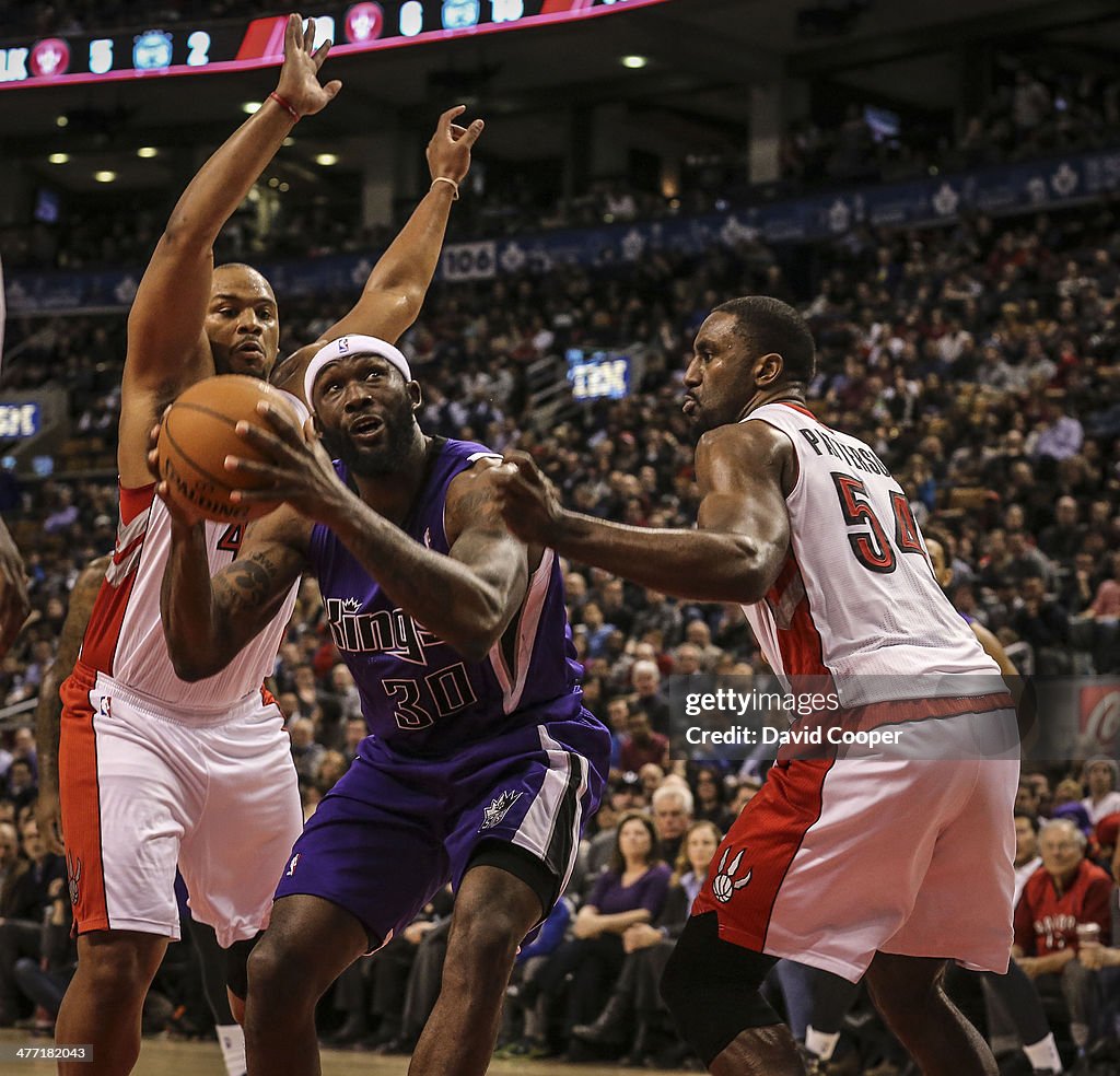 Toronto Raptors power forward Chuck Hayes (44)and Toronto Raptors power forward Patrick Patterson (54) defend uner the basket against Sacramento Kings power forward Reggie Evans (30) late in the game