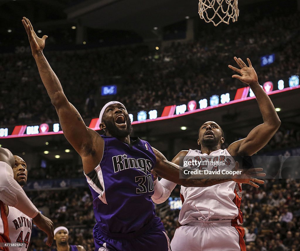 Toronto Raptors power forward Chuck Hayes (44)and Toronto Raptors power forward Patrick Patterson (54) defend uner the basket against Sacramento Kings power forward Reggie Evans (30) late in the game