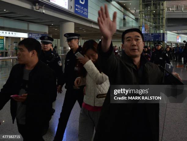 Possible relative cries at the Beijing Airport after news of the missing Malaysia Airlines Boeing 777-200 plane in Beijing on March 8, 2014. Malaysia...