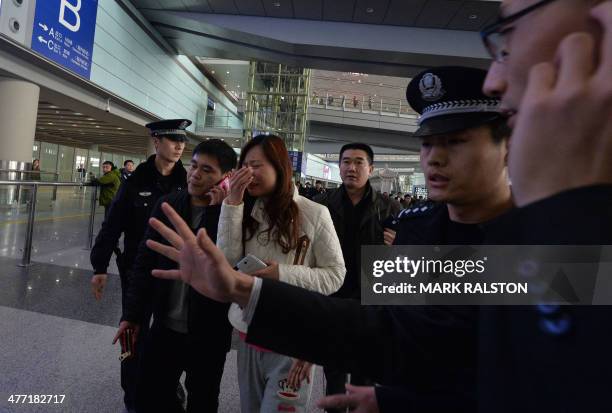 Possible relative cries at the Beijing Airport after news of the missing Malaysia Airlines Boeing 777-200 plane in Beijing on March 8, 2014. Malaysia...