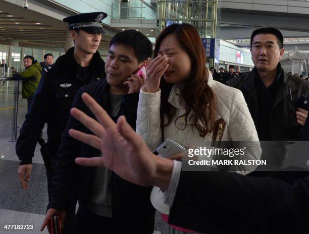 Possible relative cries at the Beijing Airport after news of the missing Malaysia Airlines Boeing 777-200 plane in Beijing on March 8, 2014. Malaysia...