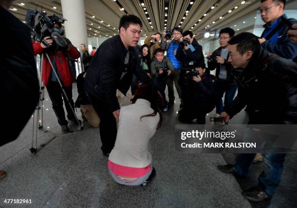 Possible relative cries at the Beijing Airport after news of the missing Malaysia Airlines Boeing 777-200 plane in Beijing on March 8, 2014. Malaysia...