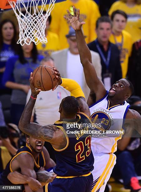 LeBron James of the Cleveland Cavaliers shoots under pressure from Draymond Green of the Golden State Warriors during Game 5 of the 2015 NBA Finals...
