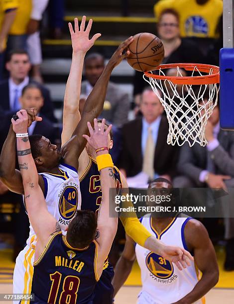 Harrison Barnes of the Golden State Warriors scores under pressure from Timofey Mozgov of the Cleveland Cavaliers during Game 5 of the 2015 NBA...
