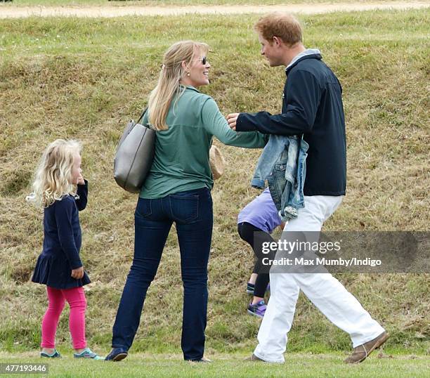 Autumn Phillips greets Prince Harry as they attend the Gigaset Charity Polo Match at the Beaufort Polo Club on June 14, 2015 in Tetbury, England.