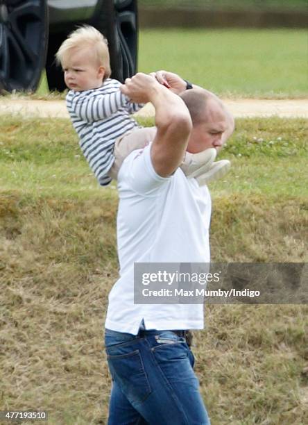 Mike Tindall carries daughter Mia Tindall on his shoulders as he attends the Gigaset Charity Polo Match at the Beaufort Polo Club on June 14, 2015 in...