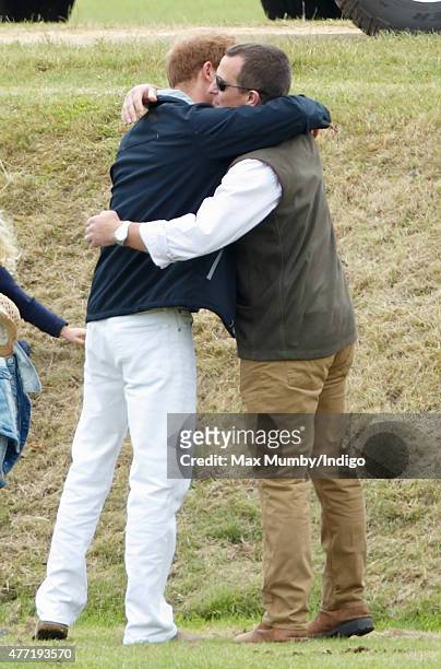 Peter Phillips greets Prince Harry as they attend the Gigaset Charity Polo Match at the Beaufort Polo Club on June 14, 2015 in Tetbury, England.