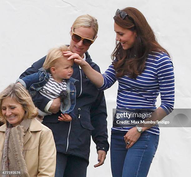 Zara Phillips with daughter Mia Tindall greets Catherine, Duchess of Cambridge as they attend the Gigaset Charity Polo Match at the Beaufort Polo...