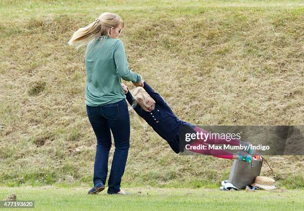 Autumn Phillips plays with daughter Savannah Phillips as they attend the Gigaset Charity Polo Match at the Beaufort Polo Club on June 14, 2015 in...