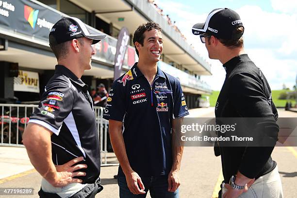 Daniel Ricciardo of Red Bull Racing talks with V8 Supercar drivers Lee Holdsworth and Will Davison during the 2014 Top Gear Festival Sydney at Sydney...