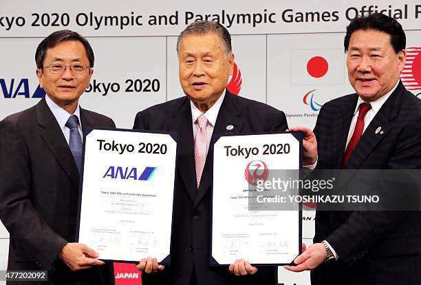 Yoshiro Mori , president of the Tokyo 2020 Olympics organising committee poses with Japan Airlines president Yoshiharu Ueki and All Nippon Airways...