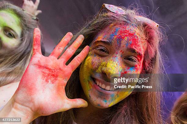 Thousands of people at the second edition of the Turin Holi Fusion, the Festival of Colors of Indian origin. In photo a girl colored in the face.