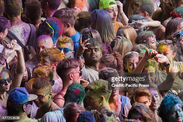 Thousands of people at the second edition of the Turin Holi Fusion, the Festival of Colors of Indian origin. An Indian boy take a selfie into the...