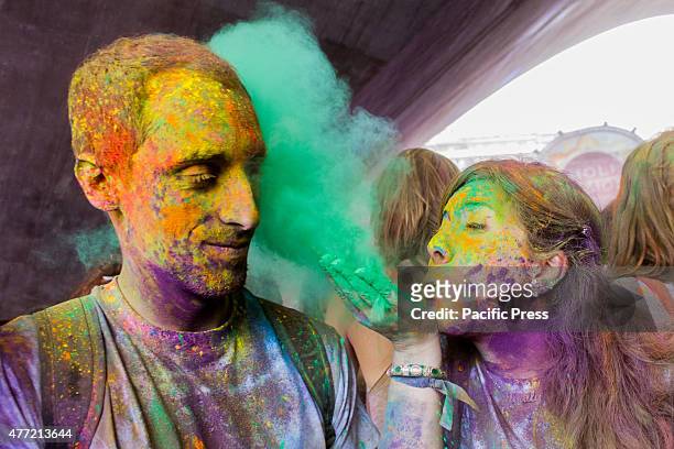 Thousands of people at the second edition of the Turin Holi Fusion, the Festival of Colors of Indian origin. In the photo a girl blows the color in...