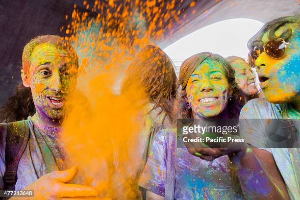 Thousands of people at the second edition of the Turin Holi Fusion, the Festival of Colors of Indian origin. In photo some friends play with colors.