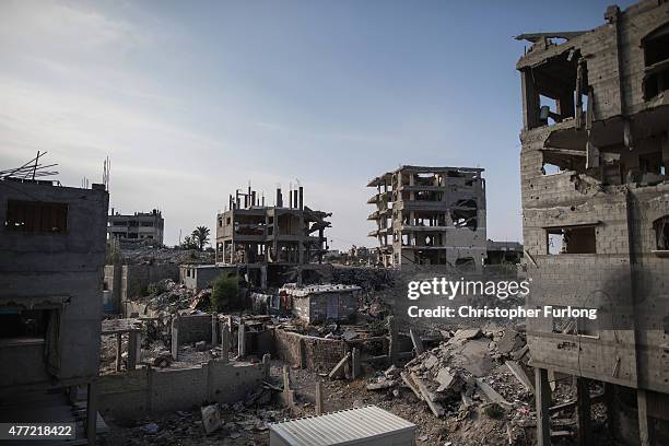 Bomb damaged homes still scar the landscape with some families still living in the dangerously unstable buildings that scar Gaza on June 15 Gaza...