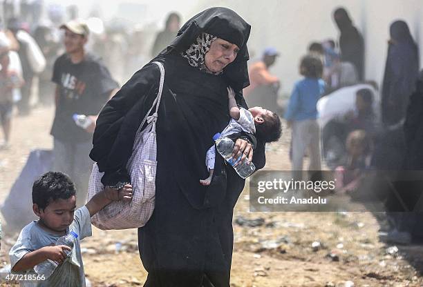 Group of Syrians, fled from clashes, cross Turkish - Syrian border to take shelter in Turkey on June 15, 2015 in Sanliurfa's Akcakale district,...
