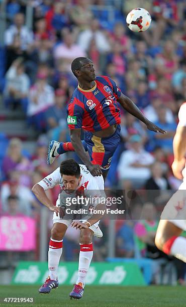 Emile Heskey of the Jets contests a header with Jonatan Germano of the Heart during the round 22 A-League match between the Newcastle Jets and...