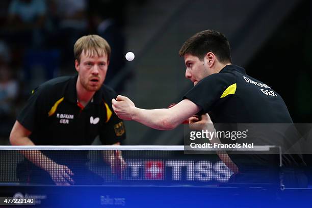 Patrick Baum and Dimitrij Ovtcharov of Germany compete in the Men's Team Table Tennis bronze medal match against Stefan Fegerl and Daniel Habesohn of...