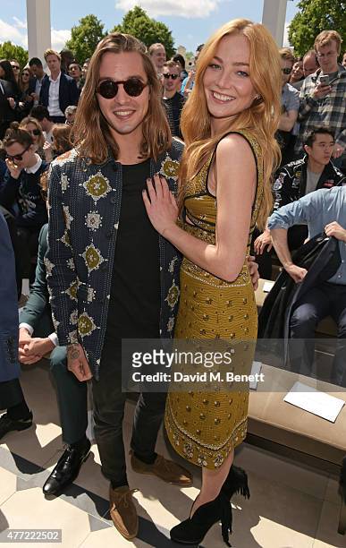 Oscar Tuttiett and Clara Paget attend the front row at Burberry Menswear Spring/Summer 2016 show at Kensington Gardens on June 15, 2015 in London,...