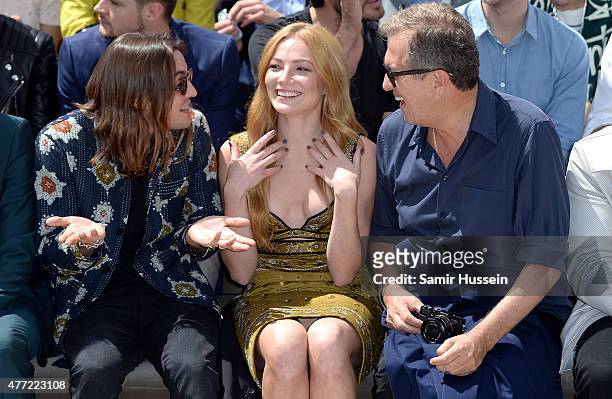 Oscar Tuttiett, Clara Paget and Mario Testino sit in the front row at Burberry Menswear Spring/Summer 2016 show at Kensington Gardens on June 15,...