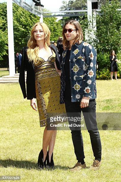 Clara Paget and Oscar Tuttiett arrive at Burberry Menswear Spring/Summer 2016 show at Kensington Gardens on June 15, 2015 in London, England.