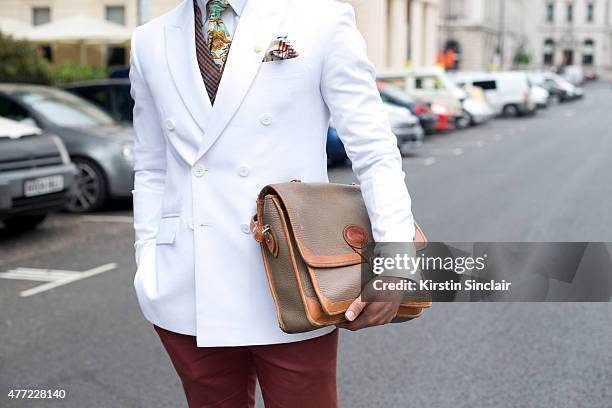 Fashion designer Saran Kohli wears Saran Kohli jacket, shirt and trousers, Duchamp pocket square, City design tie, vintage Dooney and Bourke bag on...