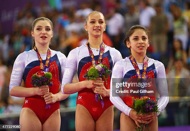 Gold medalists Aliya Mustafina, Victoria Komova and Seda Tutkhalyan of Russia stand on the podium during the medal ceremony for the Women's Team...