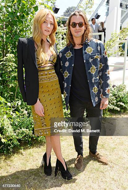 Clara Paget and Oscar Tuttiett arrive at the Burberry Menswear Spring/Summer 2016 show at Kensington Gardens on June 15, 2015 in London, England.