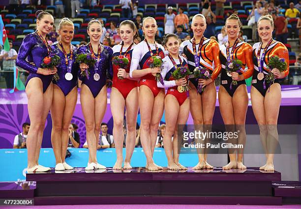 Silver medalists Sophie Scheder, Elisabeth Seitz and Leah Griesser of Germany, gold medalists Aliya Mustafina, Victoria Komova and Seda Tutkhalyan of...