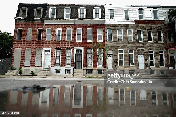Cinderblocks wall off the door and windows of a burned and abandoned rowhouse across the street from First Mt Calvary Baptist Church, where U.S. Sen....