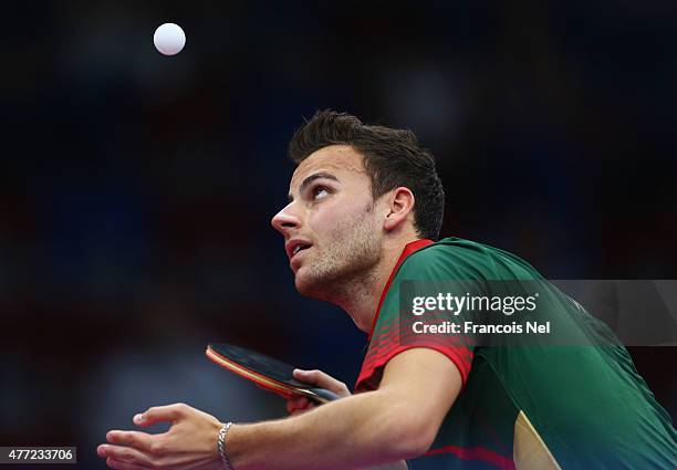 Tiago Apolonia of Portugal competes in the Men's Table Tennis Team gold medal match one against Adrien Mattenet of France during day three of the...