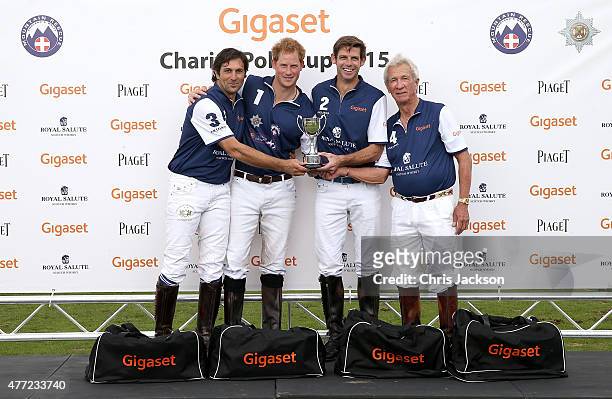 Winning team Royal Salute, Eduardo Novillo Astrada, Prince Harry, Malcolm Borwick and Sir Charles Williams collect the winning trophy at the Gigaset...