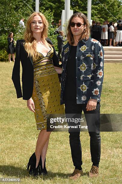 Clara Paget and Oscar Tuttiett attend the Burberry Prorsum show during The London Collections Men SS16 at on June 15, 2015 in London, England.