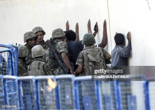 Turkish soldiers detain men came from Syria and supposed to be Islamic State fighters, near the Akcakale crossing gate between Turkey and Syria at...