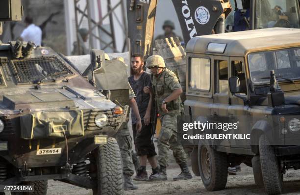 Turkish soldiers detain a man came from Syria and supposed to be an Islamic State fighter near the Akcakale crossing gate between Turkey and Syria at...