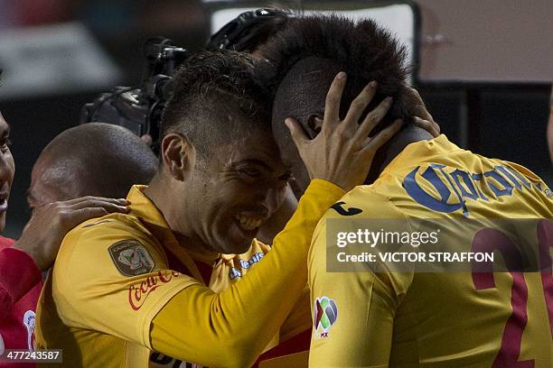 Duvier Riascos and Carlos Morales celebrate a goal against Pumas, during their Mexican Clausura tournament football match on March 7, 2014 in...