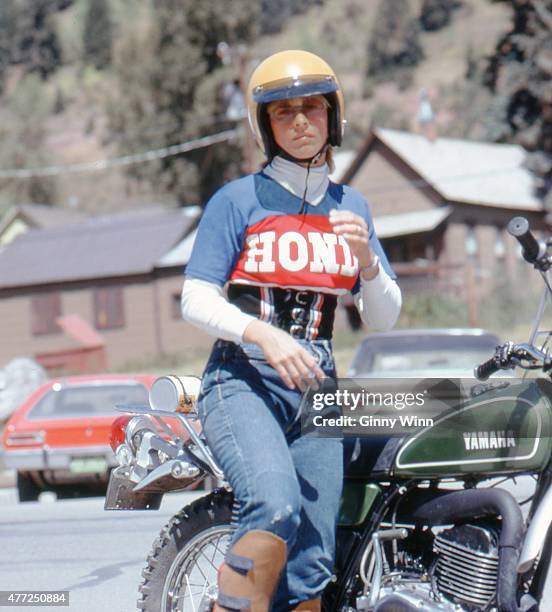 An unidentified woman wearing a Honda shirt and riding a Yamaha motorcycle poses for a photo during the first annual Telluride Film Festival in 1974...