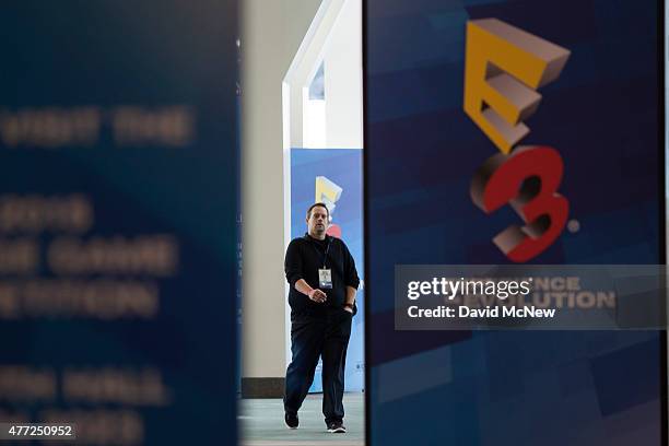 Man walks between signage as workers make final preparations for opening day of E3 at the the Los Angles Convention Center on June 15, 2015 in Los...