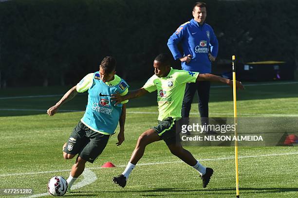 Brazil's players Roberto Firmino and Robinho take part in a training session at the Azul training centre in Santiago, on June 15, 2015. Brazil will...