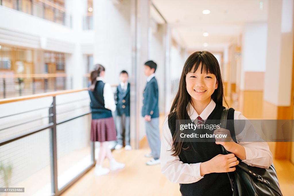 Japanese high school. Young student, three friends in the background