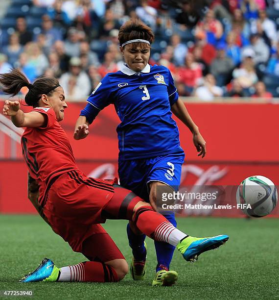 Dzsenifer Marozsan of Germany tackles Natthakarn Chinwong of Thailand during the FIFA Women's World Cup 2015 Group B match between Thailand and...