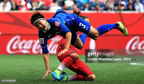 Dzsenifer Marozsan of Germany tackles Natthakarn Chinwong of Thailand during the FIFA Women's World Cup 2015 Group B match between Thailand and...