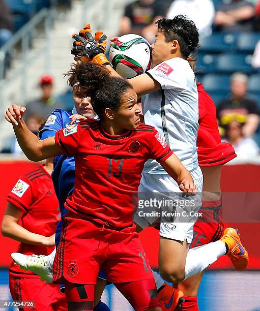 Goalkeeper Waraporn Boonsing of Thailand saves a shot on goal against Celia Sasic and Melanie Leupolz of Germany during the FIFA Women's World Cup...