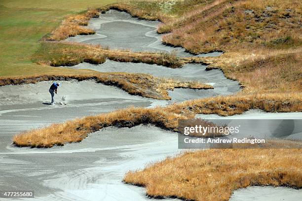 Martin Kaymer of Germany hits a shot from a bunker during a practice round prior to the start of the 115th U.S. Open Championship at Chambers Bay on...