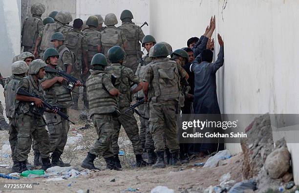 Turkish soldiers detain men came from Syria and supposed to be Islamic State fighters, near the Akcakale crossing gate between Turkey and Syria at...