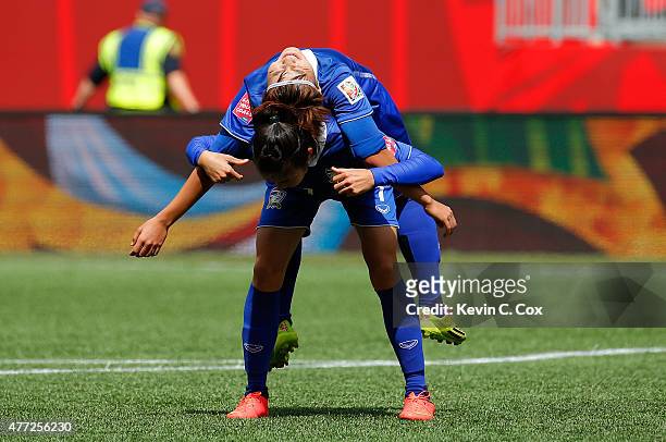 Silawan Intamee of Thailand stretches Natthakarn Chinwong after the first half against Germany during the FIFA Women's World Cup Canada 2015 match...