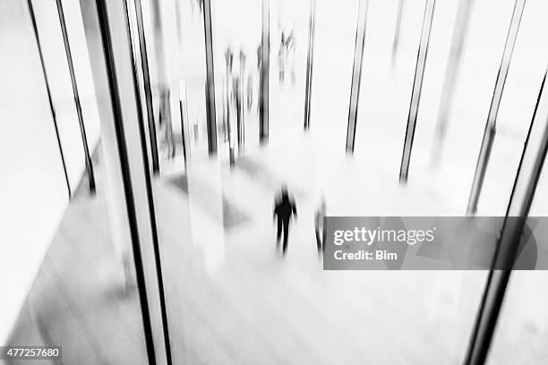 abstract black and white image of lobby with blurred people - bokeh museum stock pictures, royalty-free photos & images